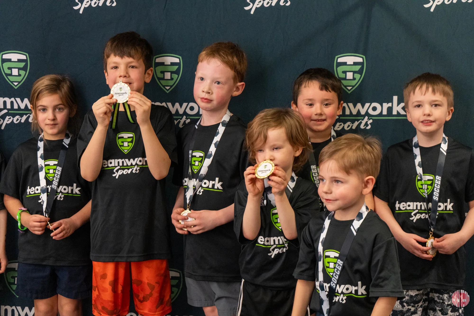 Young basketball players showing off their Teamwork awards