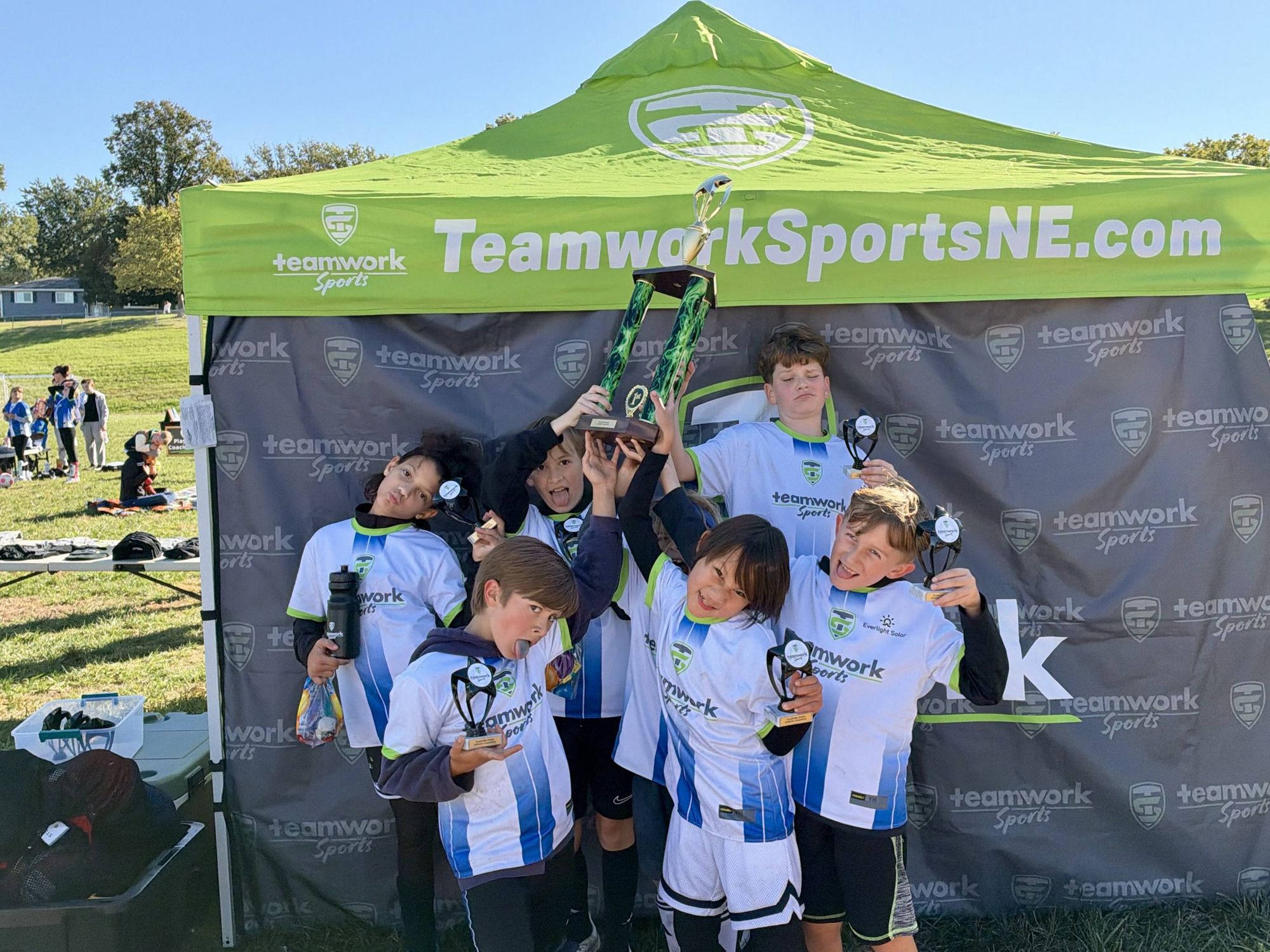 A Teamwork team celebrating together under the tent