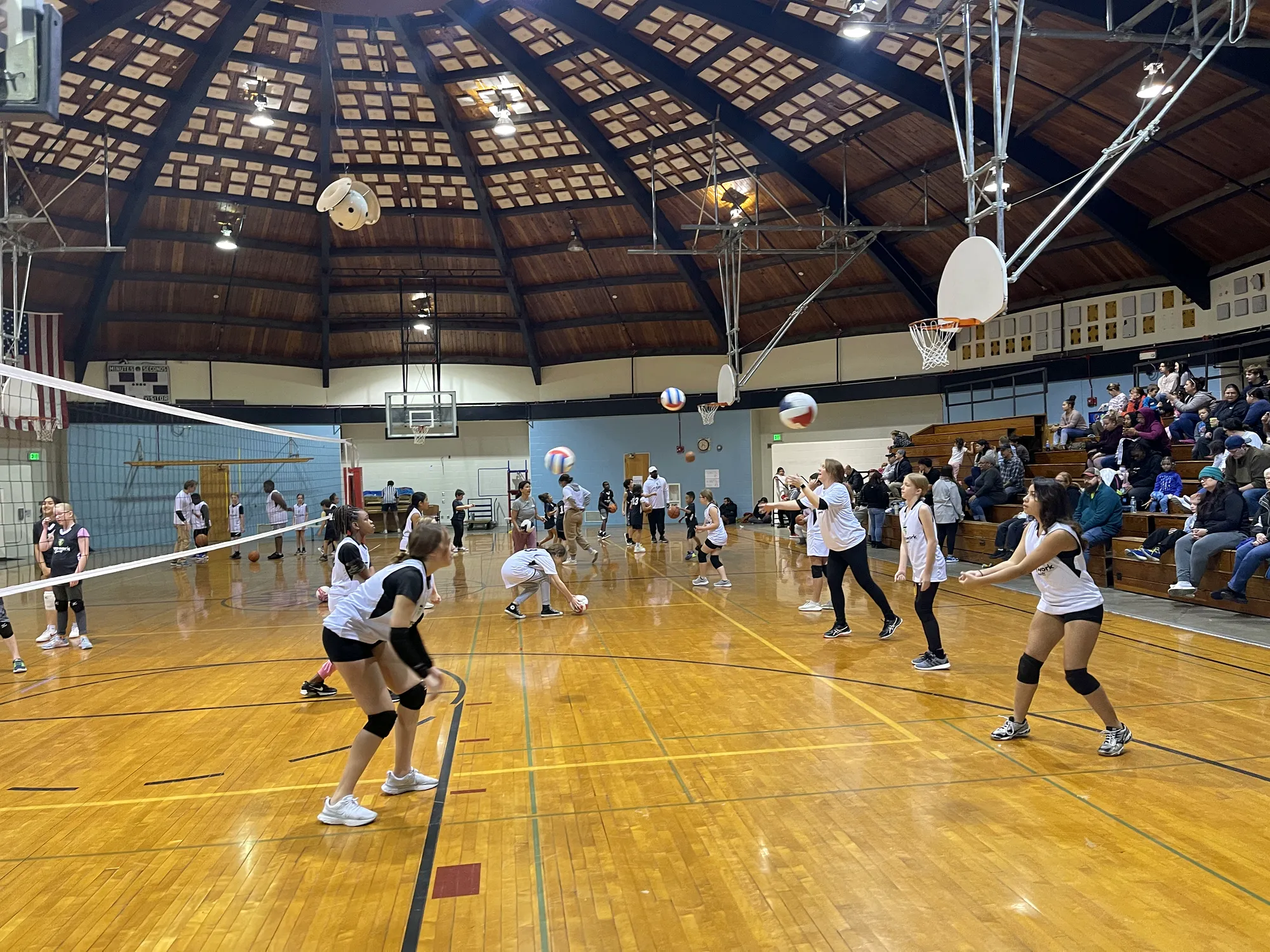 A youth volleyball game in a full gym